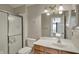 Bathroom featuring a vanity with solid surface top, mirror, and a glass enclosed shower at 12588 Tennyson Ln # 205, Carmel, IN 46032