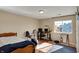 Bedroom with hardwood floors, a bed, desk, gym equipment and plenty of natural light at 12588 Tennyson Ln # 205, Carmel, IN 46032