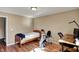 Bedroom featuring hardwood floors, a bed, desk, gym equipment and plenty of natural light at 12588 Tennyson Ln # 205, Carmel, IN 46032