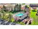 A fenced community pool is surrounded by lounge chairs, trees, and manicured landscaping at 12588 Tennyson Ln # 205, Carmel, IN 46032