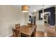 Inviting dining area with wooden table and contemporary pendant lighting at 12588 Tennyson Ln # 205, Carmel, IN 46032