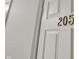 Close-up of a white apartment door with a gold number '205' displayed at 12588 Tennyson Ln # 205, Carmel, IN 46032