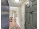 Open entryway with wood floors, a stylish front door, and a glimpse of the living area at 12588 Tennyson Ln # 205, Carmel, IN 46032