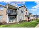 Exterior view of condo featuring a patio, balcony, lawn, and red front door at 12588 Tennyson Ln # 205, Carmel, IN 46032