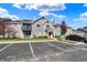 Exterior view of the property with parking in front, plus a red door and balcony at 12588 Tennyson Ln # 205, Carmel, IN 46032