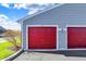 Multiple red garages showing parking space for residents at 12588 Tennyson Ln # 205, Carmel, IN 46032