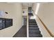 Well-lit hallway with carpeted stairs, mailboxes, and access to units on multiple floors at 12588 Tennyson Ln # 205, Carmel, IN 46032