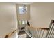 Second floor hallway featuring carpeted stairs, wood railings, and a decorative chandelier at 12588 Tennyson Ln # 205, Carmel, IN 46032