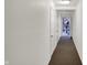 Clean hallway with neutral walls and carpet, leading to various units and a fitness center at 12588 Tennyson Ln # 205, Carmel, IN 46032