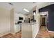 Modern kitchen with stainless steel appliances and breakfast bar seating at 12588 Tennyson Ln # 205, Carmel, IN 46032
