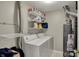 Functional laundry room equipped with washer, dryer, and shelving for ample storage at 12588 Tennyson Ln # 205, Carmel, IN 46032