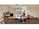 Cozy living room with fireplace, plush seating, and access to outdoor deck at 12588 Tennyson Ln # 205, Carmel, IN 46032