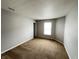 A well-lit bedroom features neutral walls, plush carpet, and a bright window at 12657 Republic Dr, Fishers, IN 46037