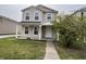 Inviting two-story home with a cozy front porch and well-manicured lawn at 12657 Republic Dr, Fishers, IN 46037