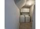A functional laundry area with modern washer, dryer, and overhead cabinets at 12657 Republic Dr, Fishers, IN 46037