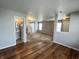 Spacious open-concept living room featuring hardwood floors and a glimpse of the bathroom at 12657 Republic Dr, Fishers, IN 46037