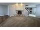 Cozy living room featuring a stone fireplace and views of the kitchen at 12657 Republic Dr, Fishers, IN 46037