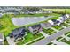Aerial view of homes and pond highlighting community layout, landscaping, and water feature, offering a picturesque neighborhood at 132 Oakhurst Way, Westfield, IN 46074
