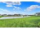 Expansive backyard with lush lawn and pond views, showcasing a peaceful and picturesque outdoor living space at 132 Oakhurst Way, Westfield, IN 46074
