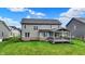 Spacious backyard with covered patio and well-manicured lawn, offering a perfect setting for outdoor living and entertaining at 132 Oakhurst Way, Westfield, IN 46074
