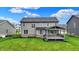 Well-maintained backyard featuring a covered deck and green lawn, ideal for relaxing and enjoying the outdoor space at 132 Oakhurst Way, Westfield, IN 46074