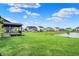 Expansive backyard with green lawn and pond views, showing the peaceful outdoor setting of the home at 132 Oakhurst Way, Westfield, IN 46074