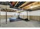 Unfinished basement space with workout equipment and exposed ceiling at 132 Oakhurst Way, Westfield, IN 46074