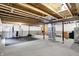Unfinished basement space featuring visible ceiling beams and gym equipment, offering potential for customization at 132 Oakhurst Way, Westfield, IN 46074