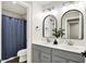 Stylish bathroom with double vanity, modern fixtures, arched mirrors and eye-catching white patterned wall at 132 Oakhurst Way, Westfield, IN 46074