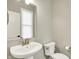This bathroom features a sleek pedestal sink, a modern faucet, and a neutral color palette at 132 Oakhurst Way, Westfield, IN 46074