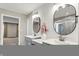 Well-lit bathroom featuring dual sinks, decorative mirrors, and shower at 132 Oakhurst Way, Westfield, IN 46074