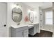 Bright bathroom featuring a double vanity, framed mirrors, decorative lighting, and tile floors at 132 Oakhurst Way, Westfield, IN 46074