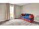 Bedroom with plush carpeting, large window with light curtains, and a blue and red play couch at 132 Oakhurst Way, Westfield, IN 46074