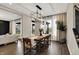 Bright dining area with a large window, modern light fixture, and seamless access to the living room at 132 Oakhurst Way, Westfield, IN 46074