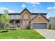 Charming two-story home with a well-manicured lawn, covered porch and attached two car garage at 132 Oakhurst Way, Westfield, IN 46074