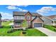 Beautiful two-story home with lush front lawn, charming covered porch and attached garage in a Gathering friendly community at 132 Oakhurst Way, Westfield, IN 46074