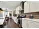 Bright kitchen with white cabinets, stainless steel appliances, and wood flooring at 132 Oakhurst Way, Westfield, IN 46074