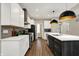 Contemporary kitchen with white cabinets, a center island with dark cabinetry, and stainless steel appliances at 132 Oakhurst Way, Westfield, IN 46074