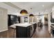 Modern kitchen with a large island, stainless steel appliances, and an open view to the dining and living areas at 132 Oakhurst Way, Westfield, IN 46074