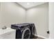 Spacious laundry room featuring a utility sink and dark blue washer and dryer at 132 Oakhurst Way, Westfield, IN 46074