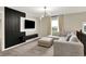 Comfortable living room featuring a modern light fixture, plush sectional sofa and a decorative accent wall at 132 Oakhurst Way, Westfield, IN 46074