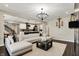 Open-concept living room with hardwood floors, a comfortable sofa, and easy access to the kitchen and dining areas at 132 Oakhurst Way, Westfield, IN 46074