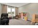 Fun playroom with plenty of space for toys, a massage chair, and a window overlooking the backyard at 132 Oakhurst Way, Westfield, IN 46074