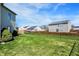 Large, grassy backyard with chain-link fence, perfect for outdoor activities and pets at 1330 Redwood Dr, Greenfield, IN 46140