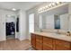 Bright bathroom with double sinks, a large mirror, and a walk-in closet at 1330 Redwood Dr, Greenfield, IN 46140