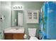 Bathroom with a single sink, toilet, and tropical themed shower curtain at 1330 Redwood Dr, Greenfield, IN 46140