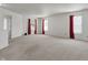 Expansive bonus room with plush carpeting, natural light, and versatile space for recreation or relaxation at 1330 Redwood Dr, Greenfield, IN 46140