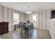 Bright dining area features striped walls, tile flooring, and a charming chandelier, perfect for Gathering meals at 1330 Redwood Dr, Greenfield, IN 46140