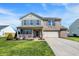 Charming two-story home with brick and siding, attached two-car garage, and covered front porch at 1330 Redwood Dr, Greenfield, IN 46140