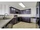 Spacious kitchen features modern appliances, dark cabinets, and ample counter space for culinary creations at 1330 Redwood Dr, Greenfield, IN 46140